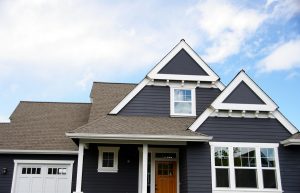 House with navy siding and pitched roof